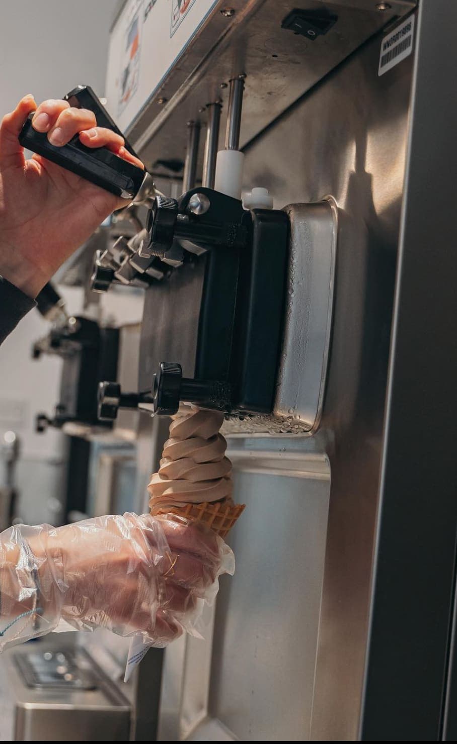 Soft serve ice cream being dispensed from a commercial machine